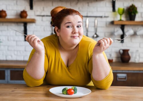 Curious fat chubby plump woman on diet for losing weight and burning calories.