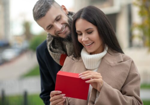 Happy young woman receiving a love letter