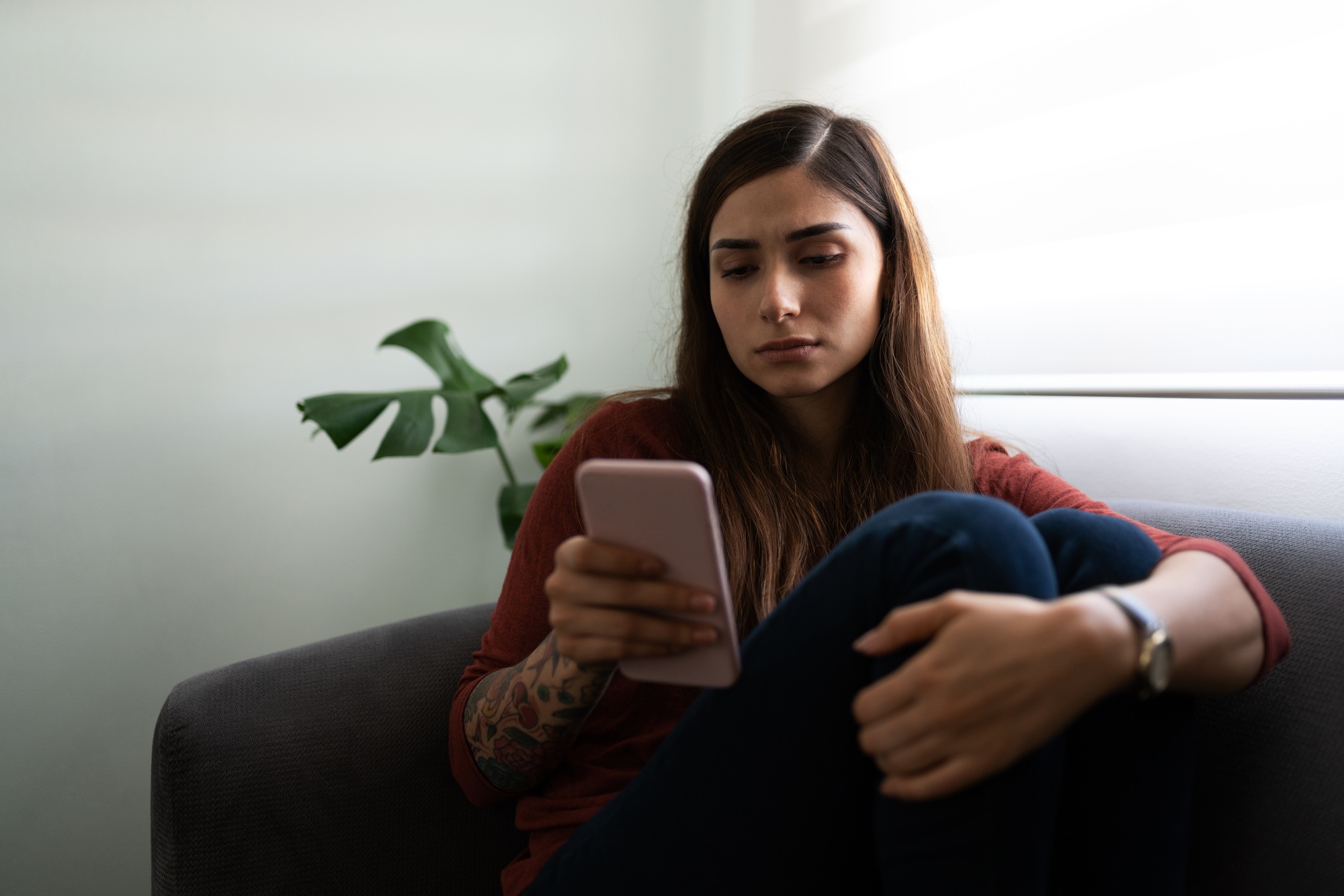 Sad woman waiting for a call or text message